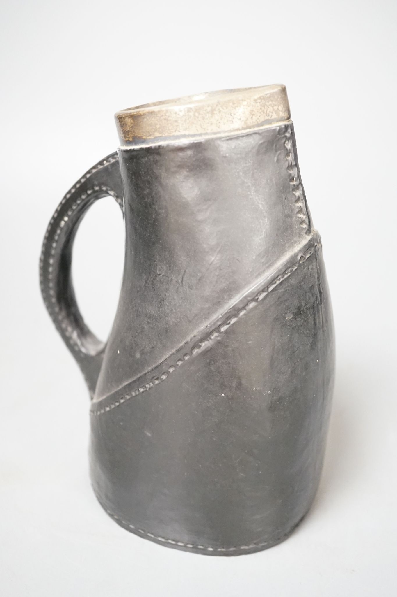 A Doulton Lambeth silver-mounted Black Jack, circa 1895. 22cm